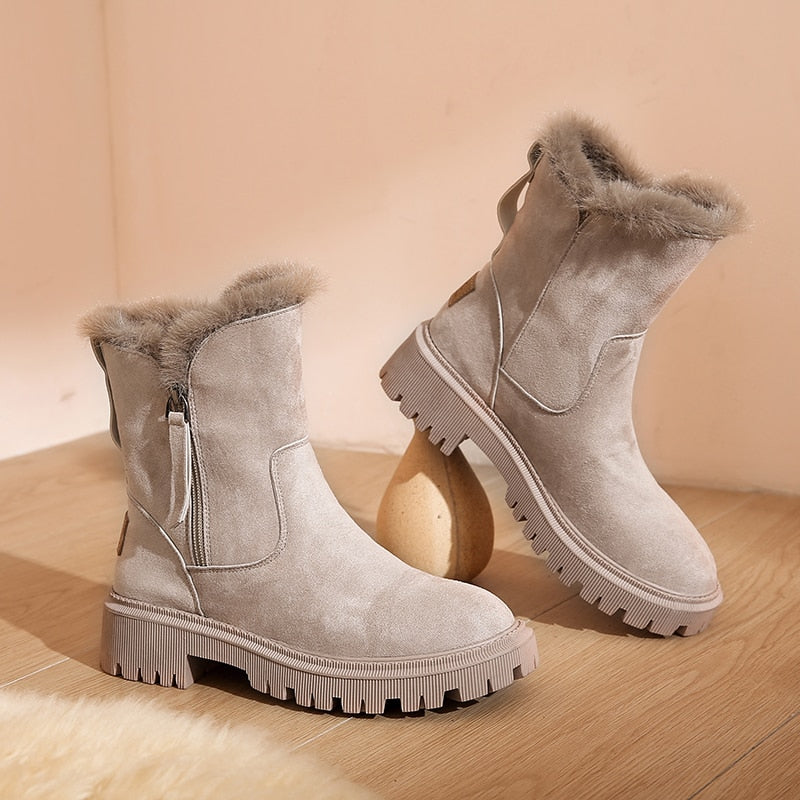 Apricot ankle boots showing stitched panels and a rear loop.