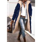 Navy-blue quilted coat worn open over casual layers.