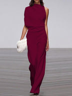 Wine-red jumpsuit with soft waist folds shown from the front.