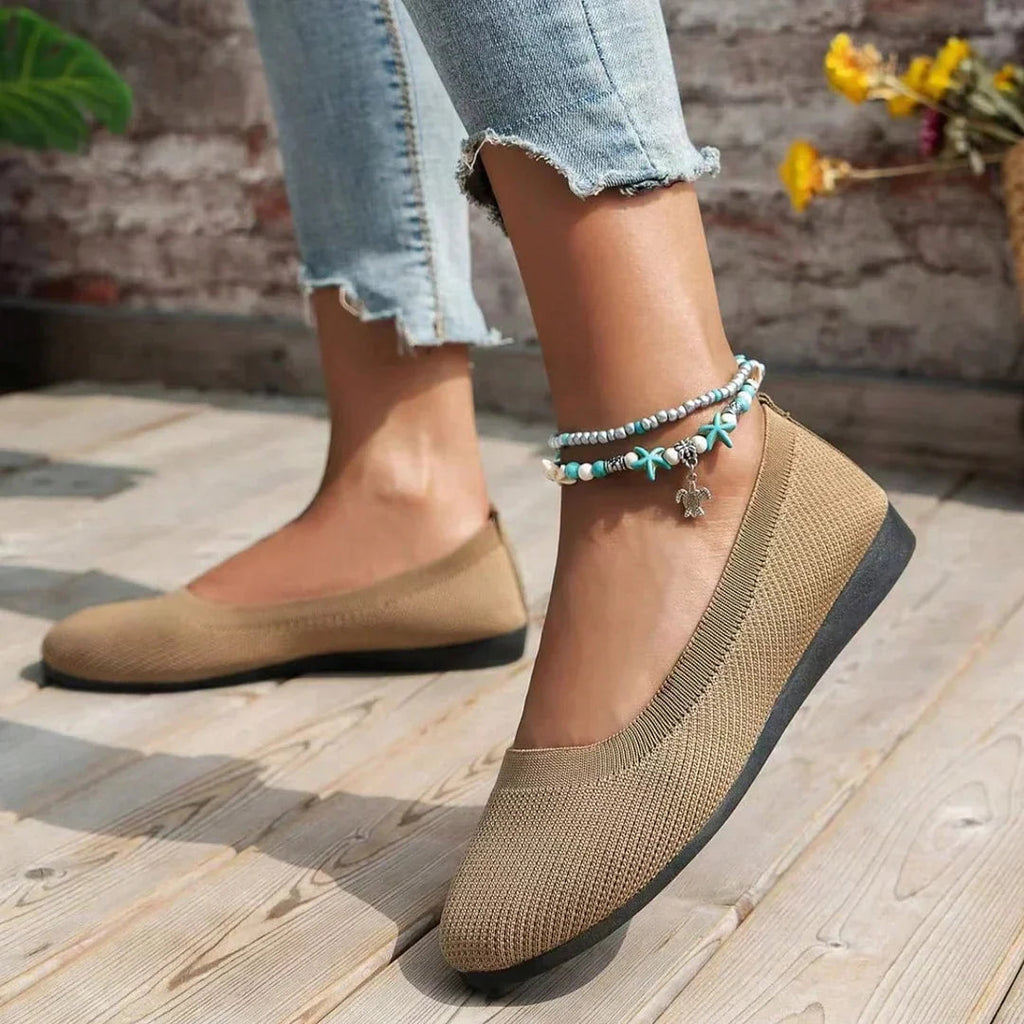 Khaki flats shown from the side while worn.