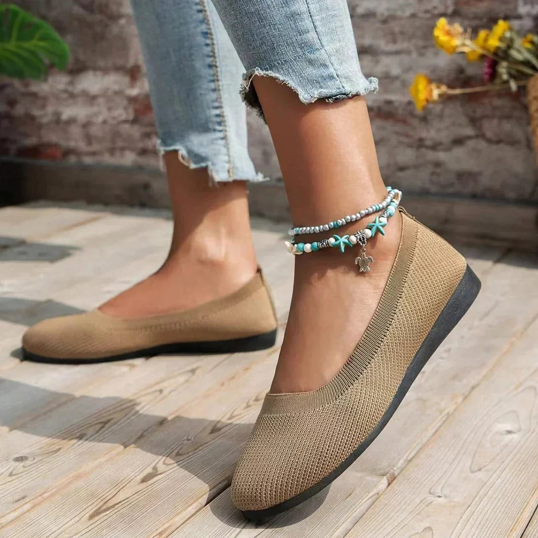 Khaki flats shown from the side while worn.