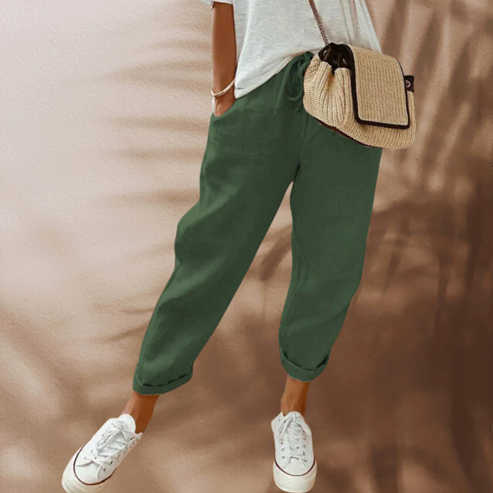 Green drawstring trousers shown with rolled hems.