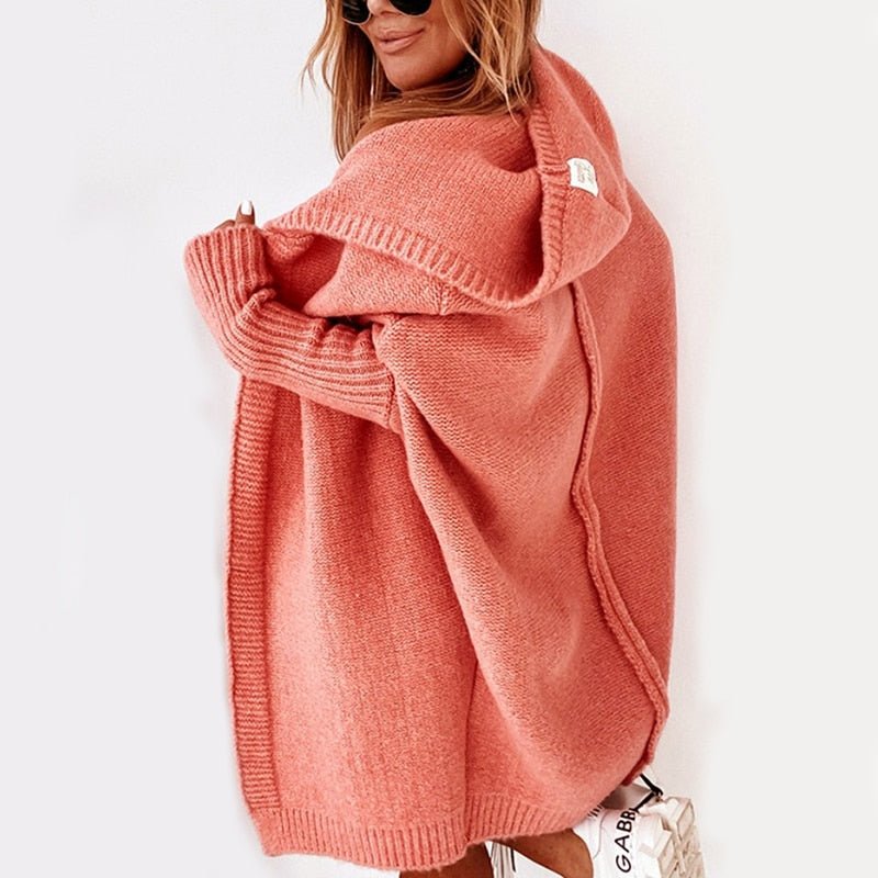 Side view of the orange cardigan with dropped shoulders.