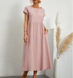 Pink Ginovu dress with short sleeves and a long skirt.