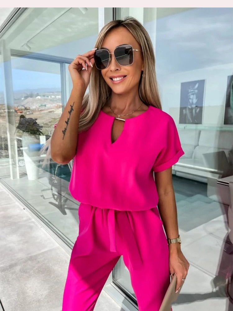 Close-up of the rose-red jumpsuit with a keyhole neckline.
