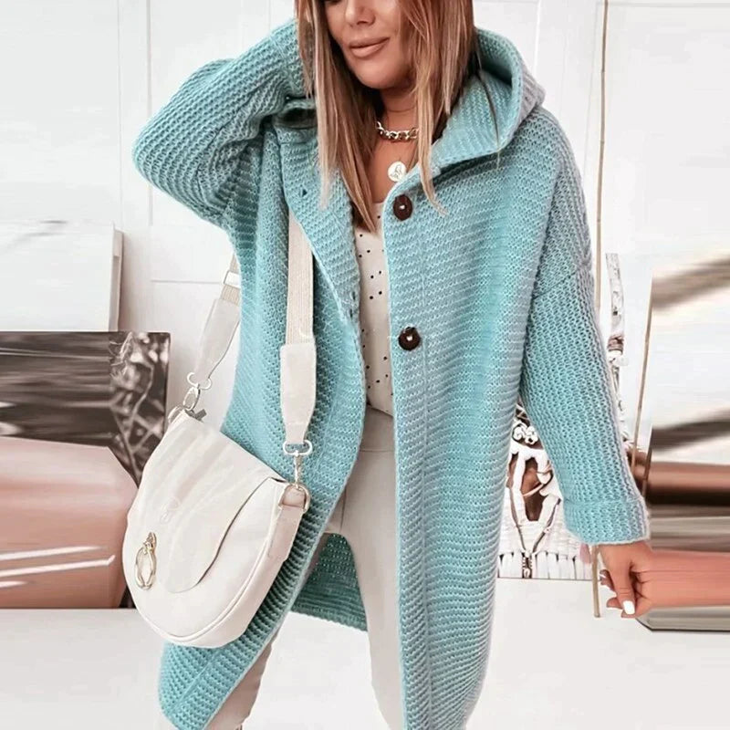 Pale blue hooded cardigan with dark front buttons and ribbed cuffs.