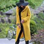 Yellow long knit cardigan worn over a black outfit.