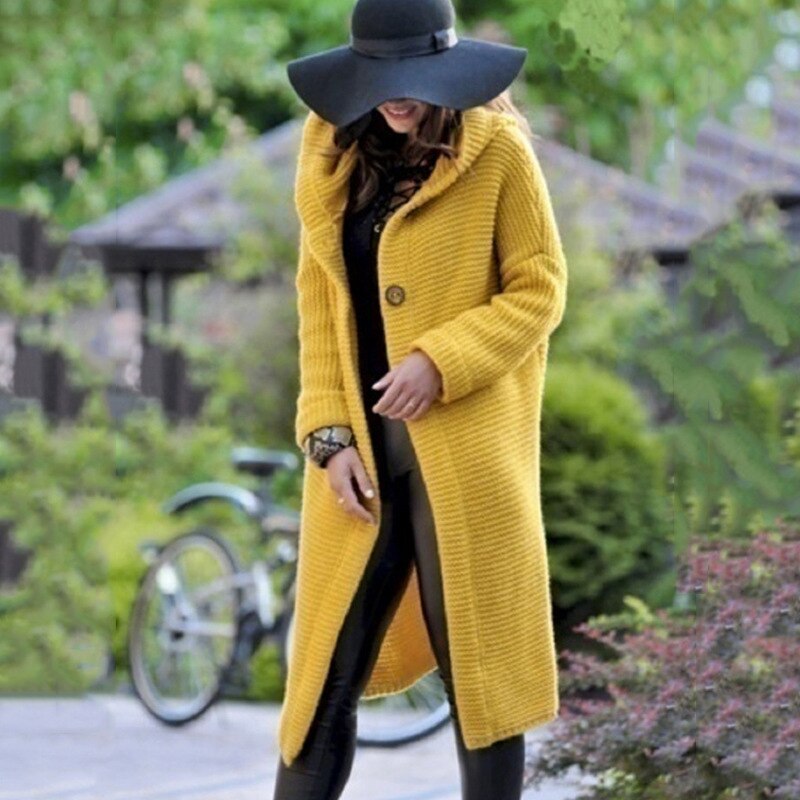 Yellow long knit cardigan worn over a black outfit.