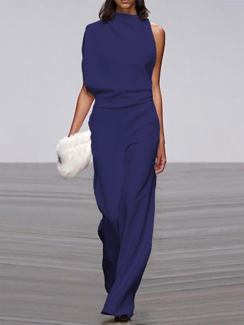 Deep blue jumpsuit with a gathered waist and long legs.