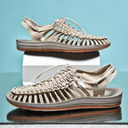 Beige cord sandals with brown-edged soles shown on display blocks.