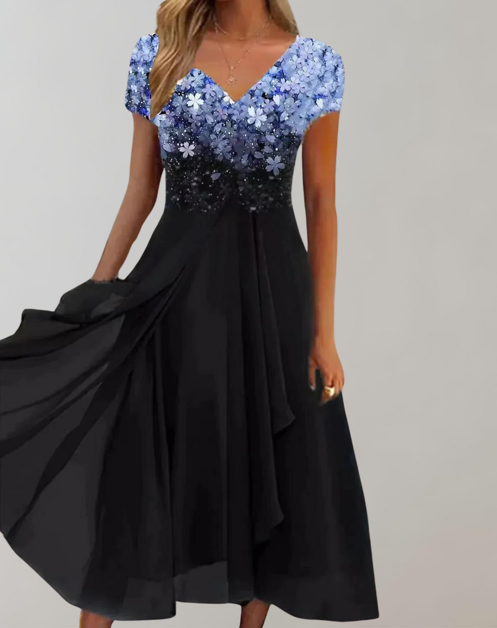 Blue floral V-neck bodice above a flowing black skirt.