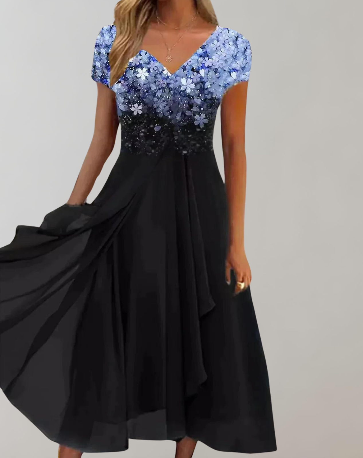 Blue floral V-neck bodice above a flowing black skirt.