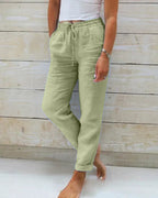 Green drawstring trousers with a relaxed leg and rolled hems.