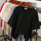 Black plain T-shirt displayed in front of other colours.