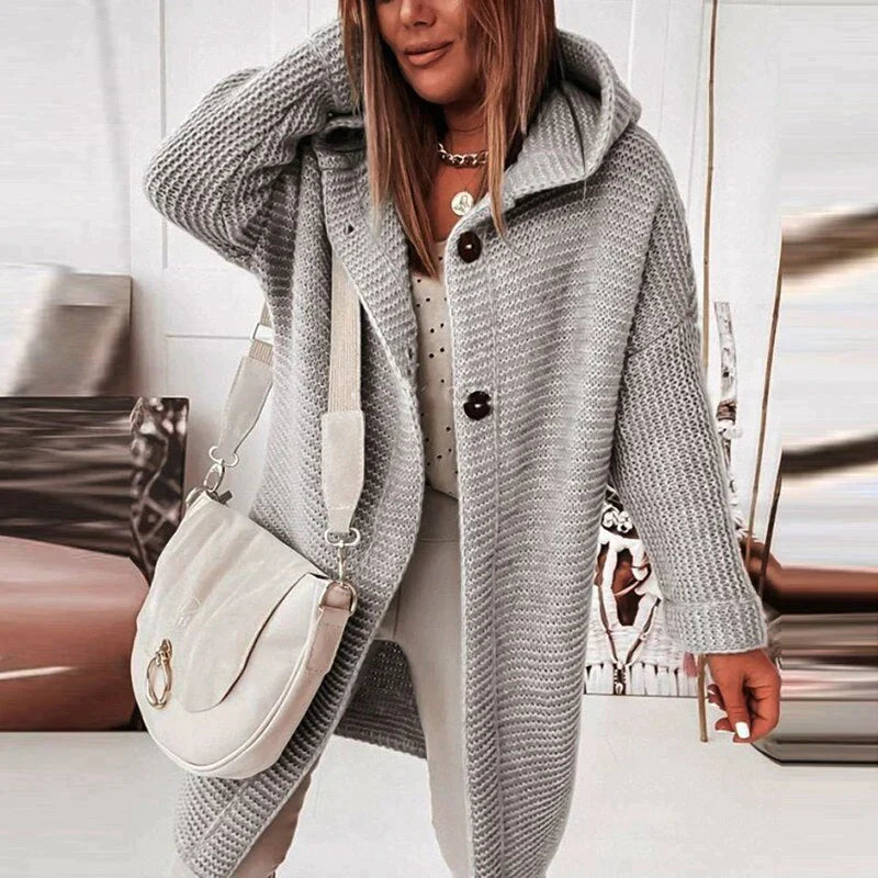 Grey hooded knit cardigan with a long body and dark front buttons.