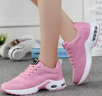Pink mesh trainers with matching laces and white soles.