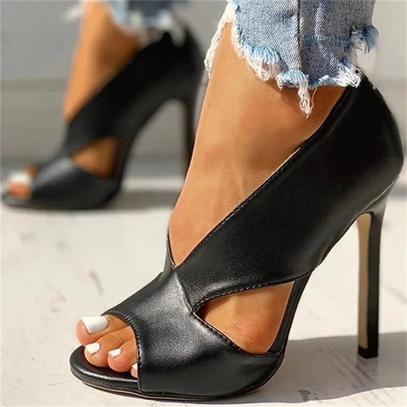 Close view of black stiletto heels with overlapping upper panels.