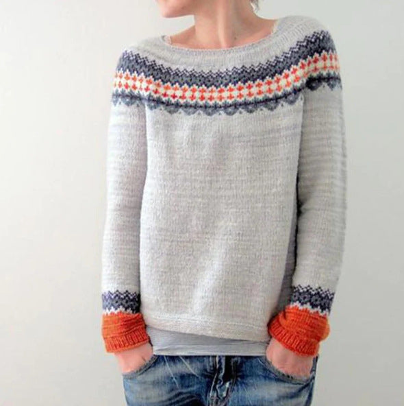 Grey knit jumper with a patterned upper band and orange cuffs.