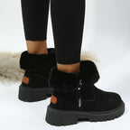 Black boots with cuffs folded down to reveal plush lining.