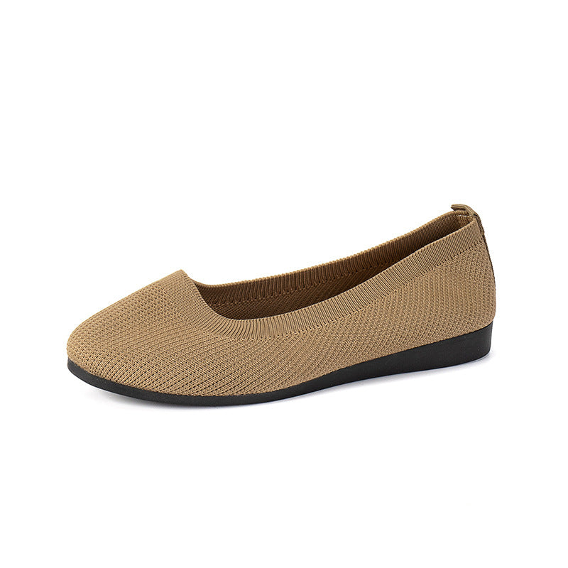 Camel-coloured slip-on flat shown from the side.
