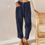 Blue trousers shown from the front with hands in the side pockets.