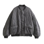 Full front view of the grey quilted bomber jacket.