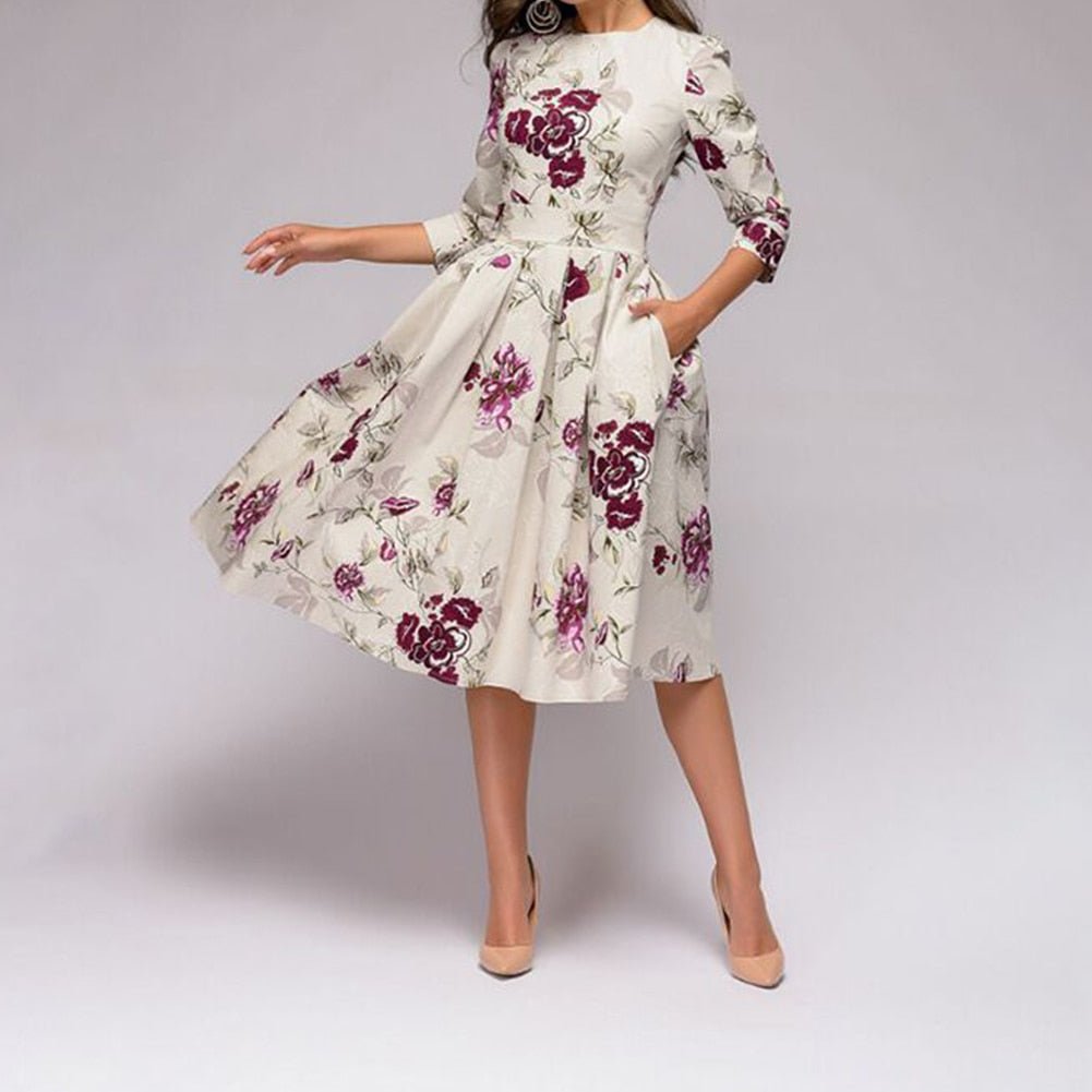 White floral midi dress shown with its skirt spread outward.