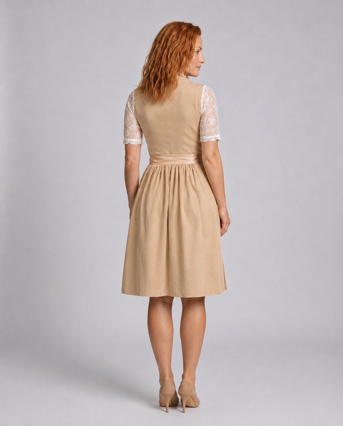 Rear view of the beige dirndl dress and white lace blouse.