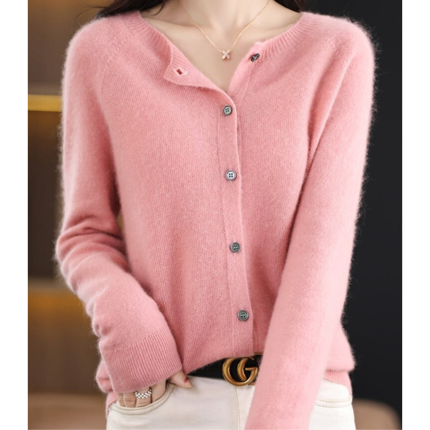 Light pink cardigan with small front buttons and ribbed cuffs.