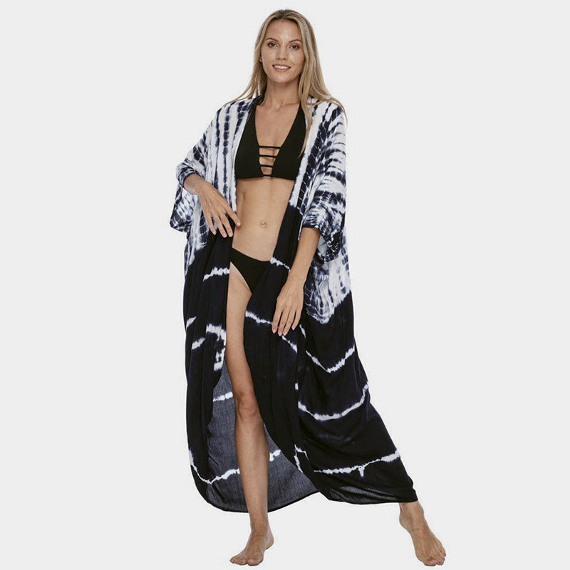 Dark and white banded cover-up worn open over a bikini.
