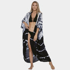 Dark and white banded cover-up worn open over a bikini.