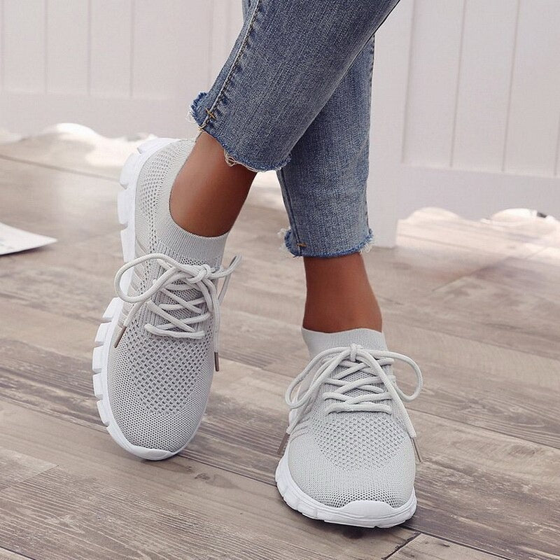 Grey trainers with matching laces and white soles.