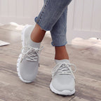 Grey trainers with matching laces and white soles.