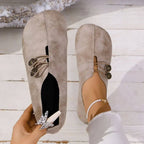 Top view of light brown slip-on shoes with decorative lacing.