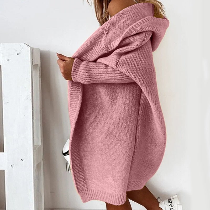 Side view of the pink cardigan with a long curved hem.