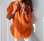 Orange textured blouse with a pointed collar and white front buttons.