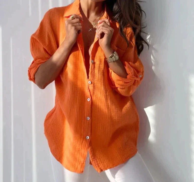 Orange textured blouse with a pointed collar and white front buttons.