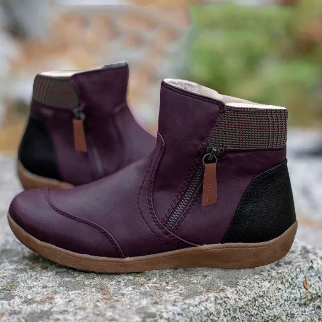 Purple ankle boots with checked collars, side zips and contrasting tan soles.