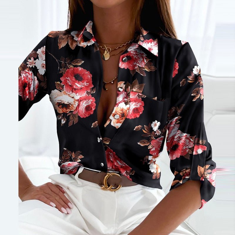 Black blouse covered with pink and red flowers.