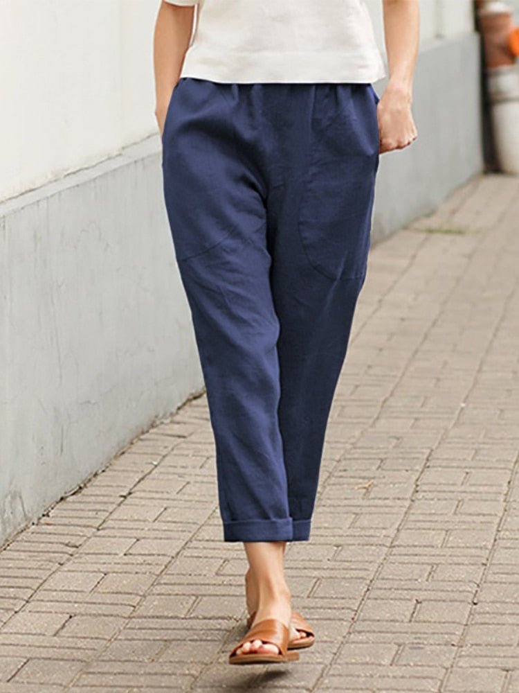 Dark blue Dayanara trousers shown worn outdoors.