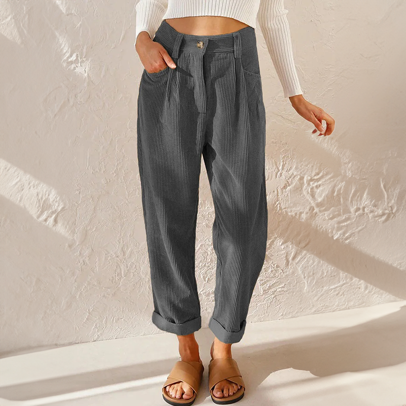 Grey corduroy trousers with turned-up hems.