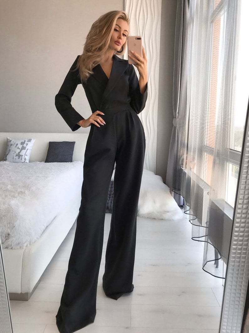 Black lapel jumpsuit with a fitted waist and wide legs.