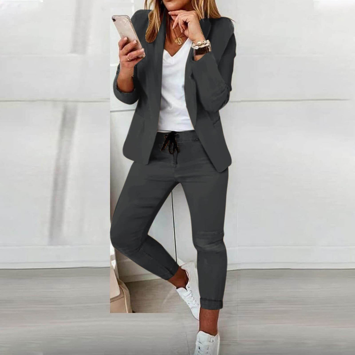 Grey blazer and matching trousers with a dark drawstring at the waist.