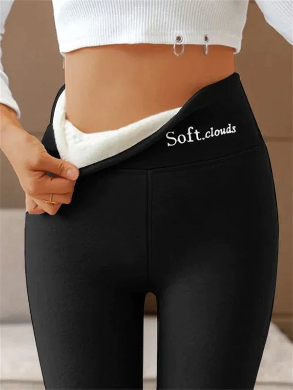 Black high-waist leggings showing the pale lining and original waistband logo.