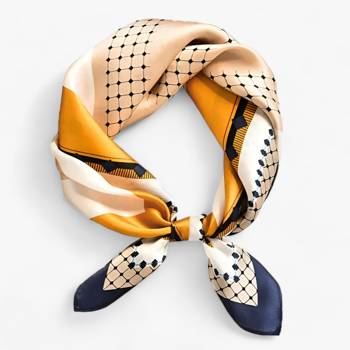 Gold and cream printed scarf with dark geometric motifs, tied in a knot.