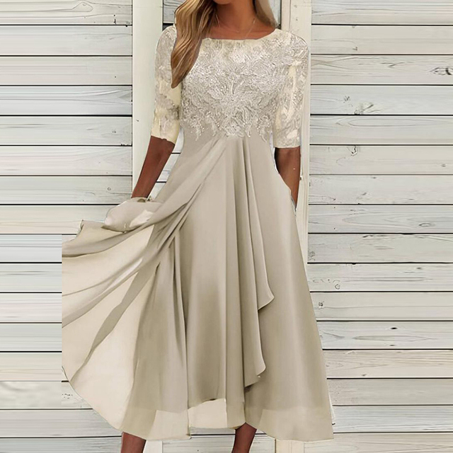 Cream-beige dress with a lace bodice and softly draped skirt.