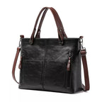 Black handbag with front pockets and a detachable brown strap.