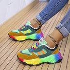 Green colourblock sneakers with side stripes and chunky rainbow soles.