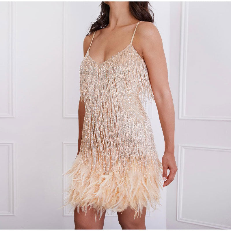 Side view of a pale rose-gold fringe dress with a V-neck and feathered hem.