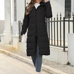 Front view of the long black puffer coat with its zip partly open.